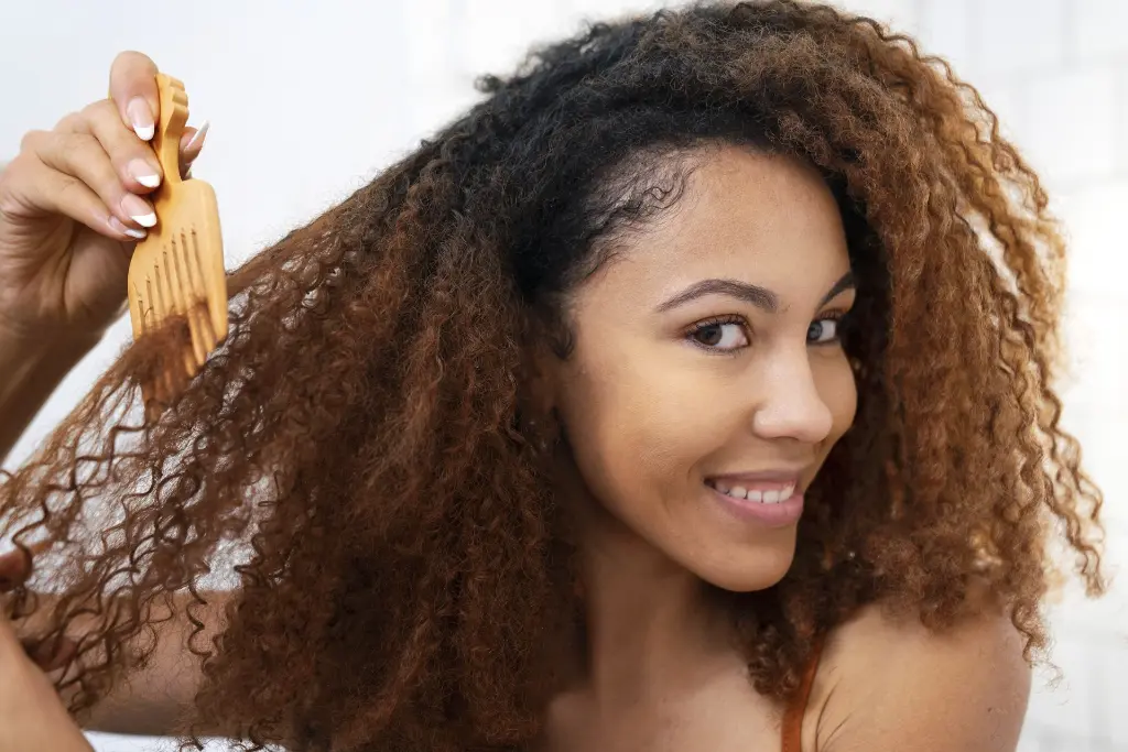 young-black-person-taking-care-afro-hair.webp